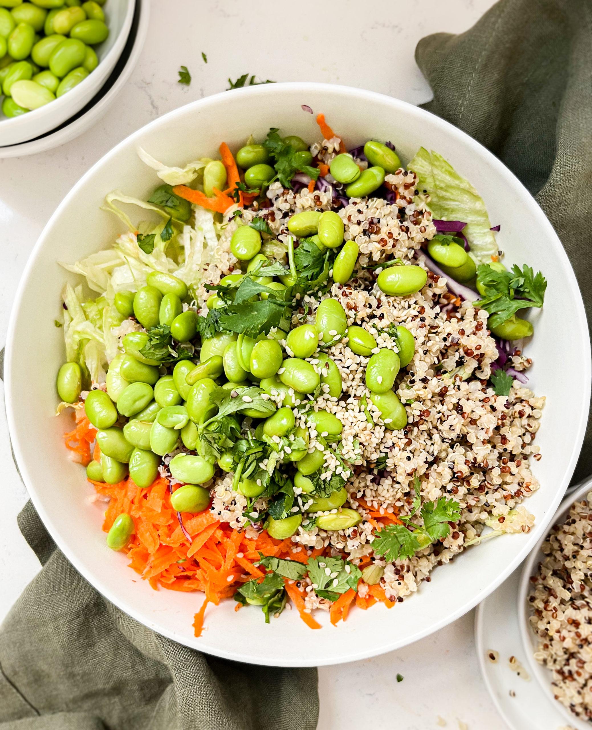 bowl of crunchy thai peanut salad on a green linen cloth