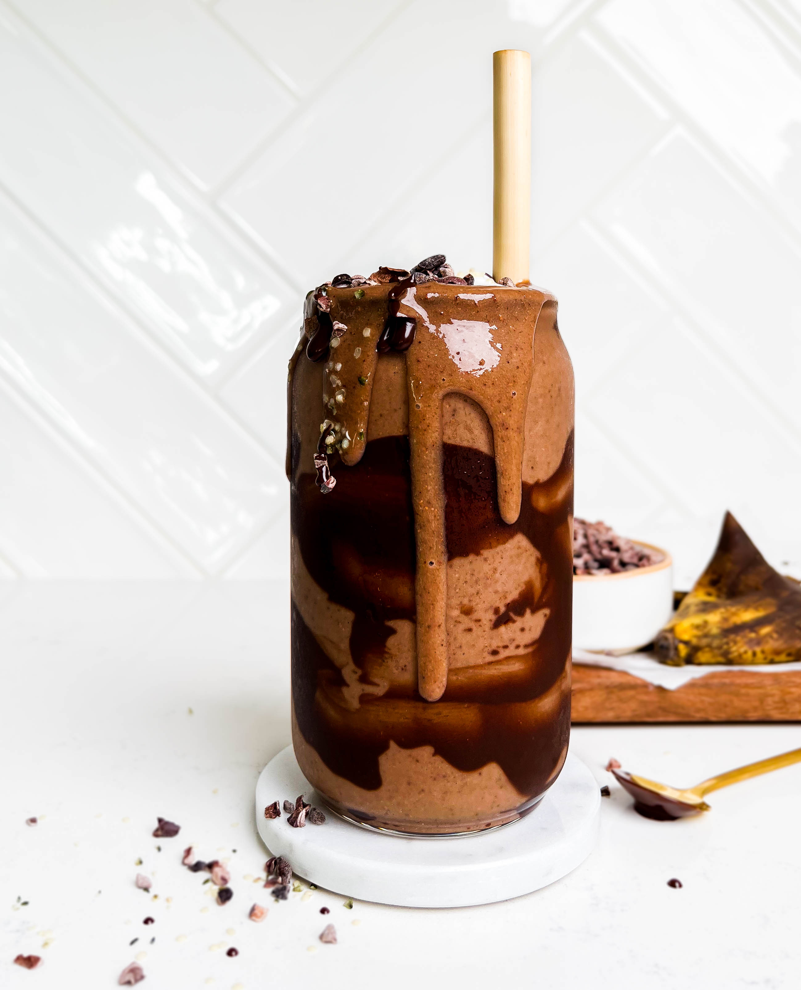 a glass of dark chocolate smoothie with chocolate swirls