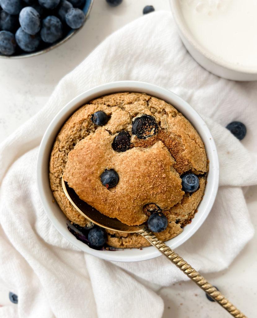 blueberry baked oats in a ramekin next to a white cloth