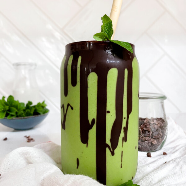 green smoothie in a glass jar on a linen cloth