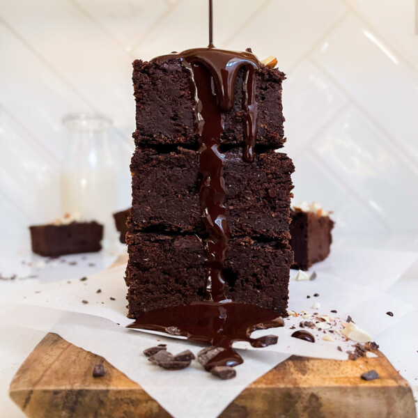 sweet potato brownies with chocolate ganache poured on top on a cutting board