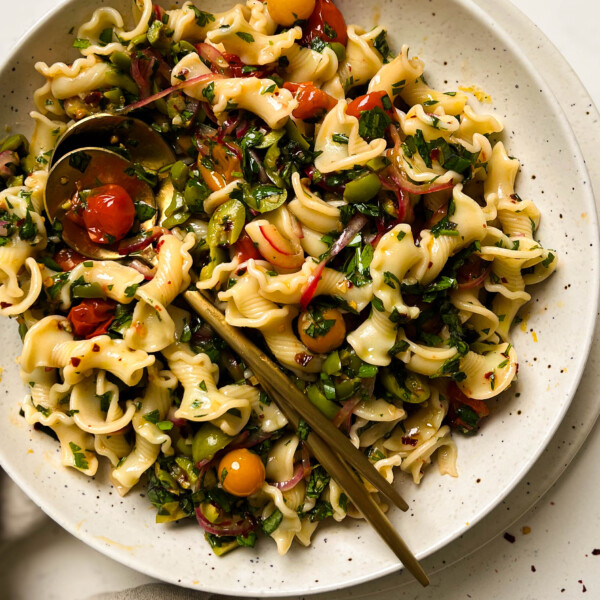 cherry tomato pasta salad in a speckled bowl