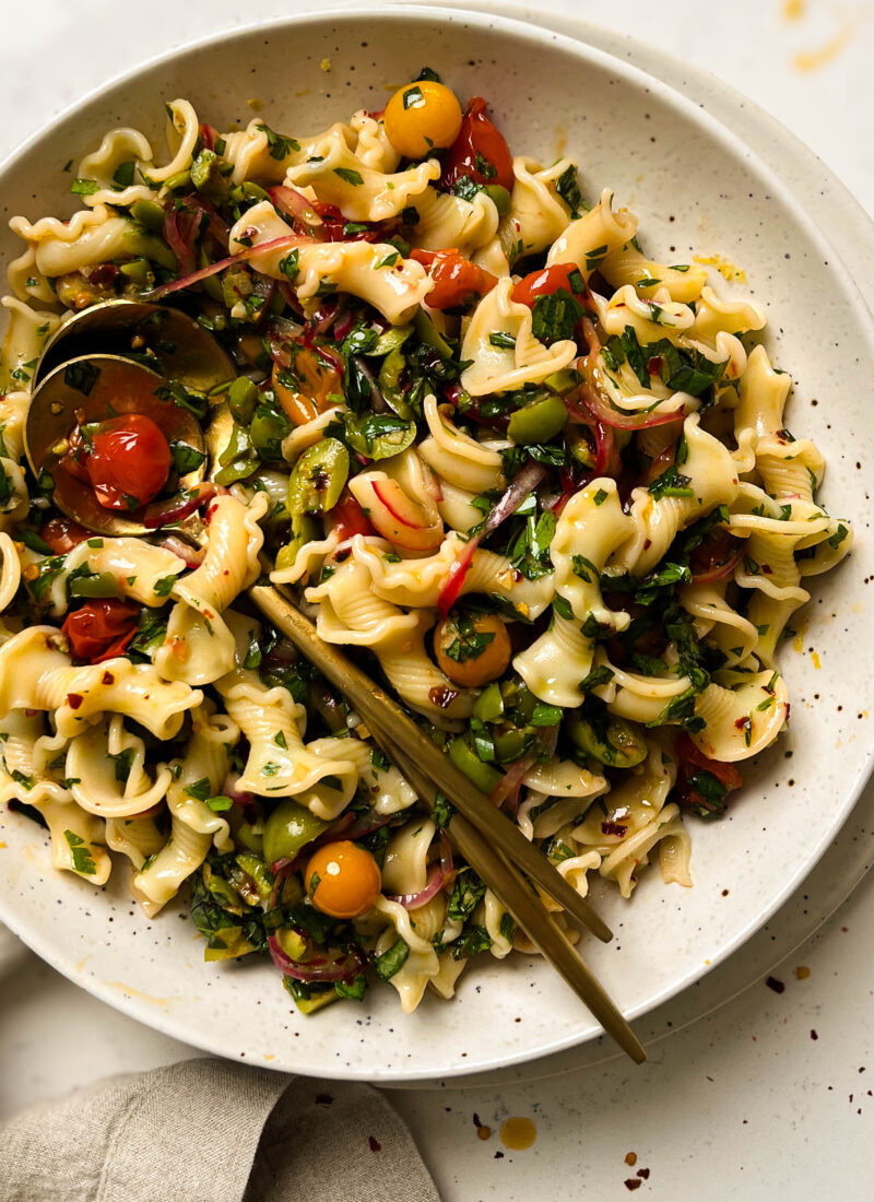 cherry tomato pasta salad in a speckled bowl