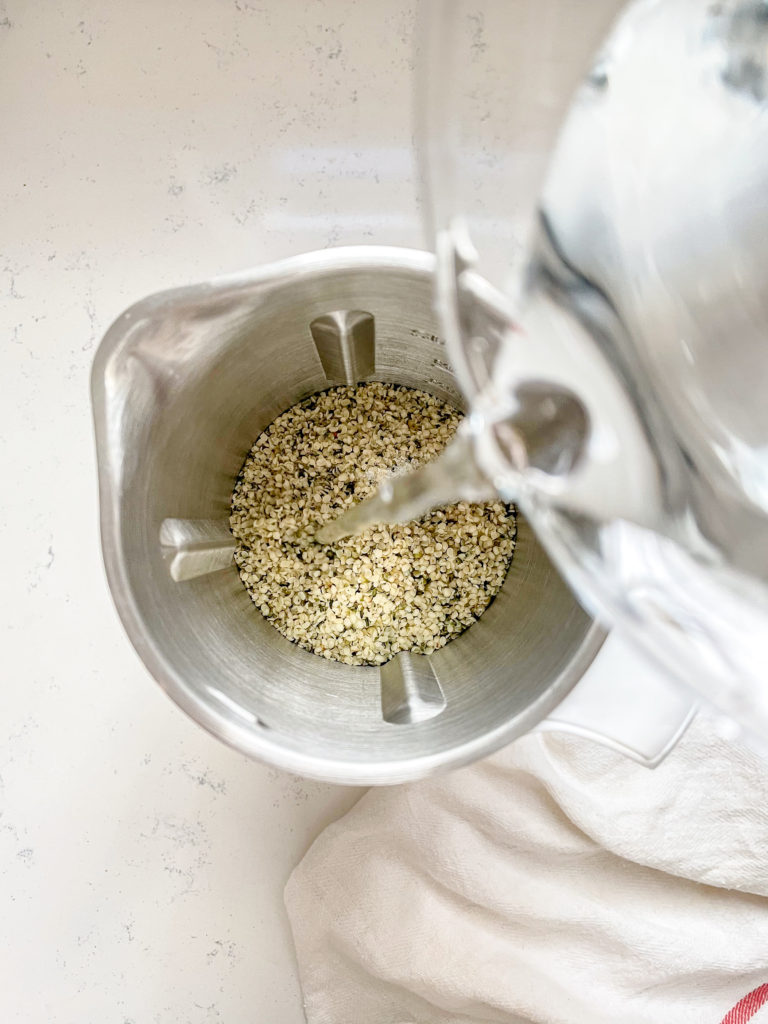 water being poured into a Nutr machine with hemp seeds 