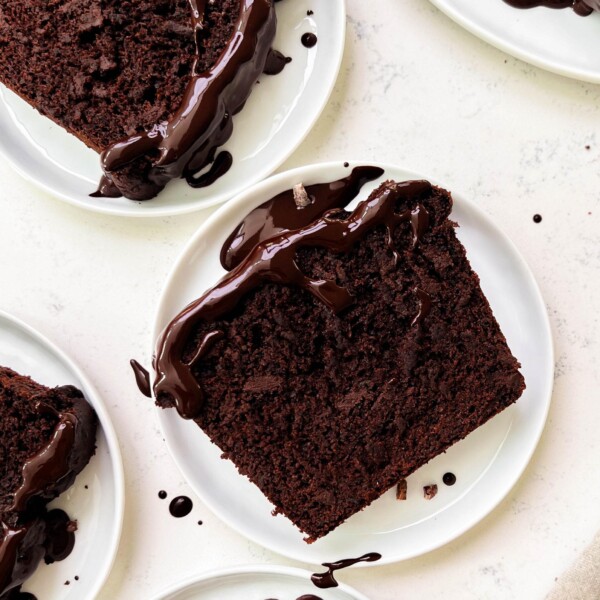 chocolate zucchini bread slices on white plates