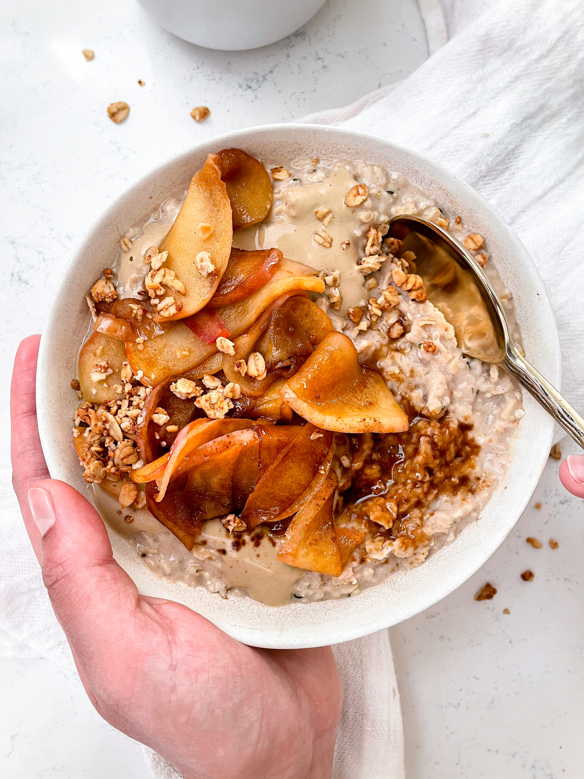 vanilla oatmeal with caramelized cinnamon sugar apples and sunflower butter on top