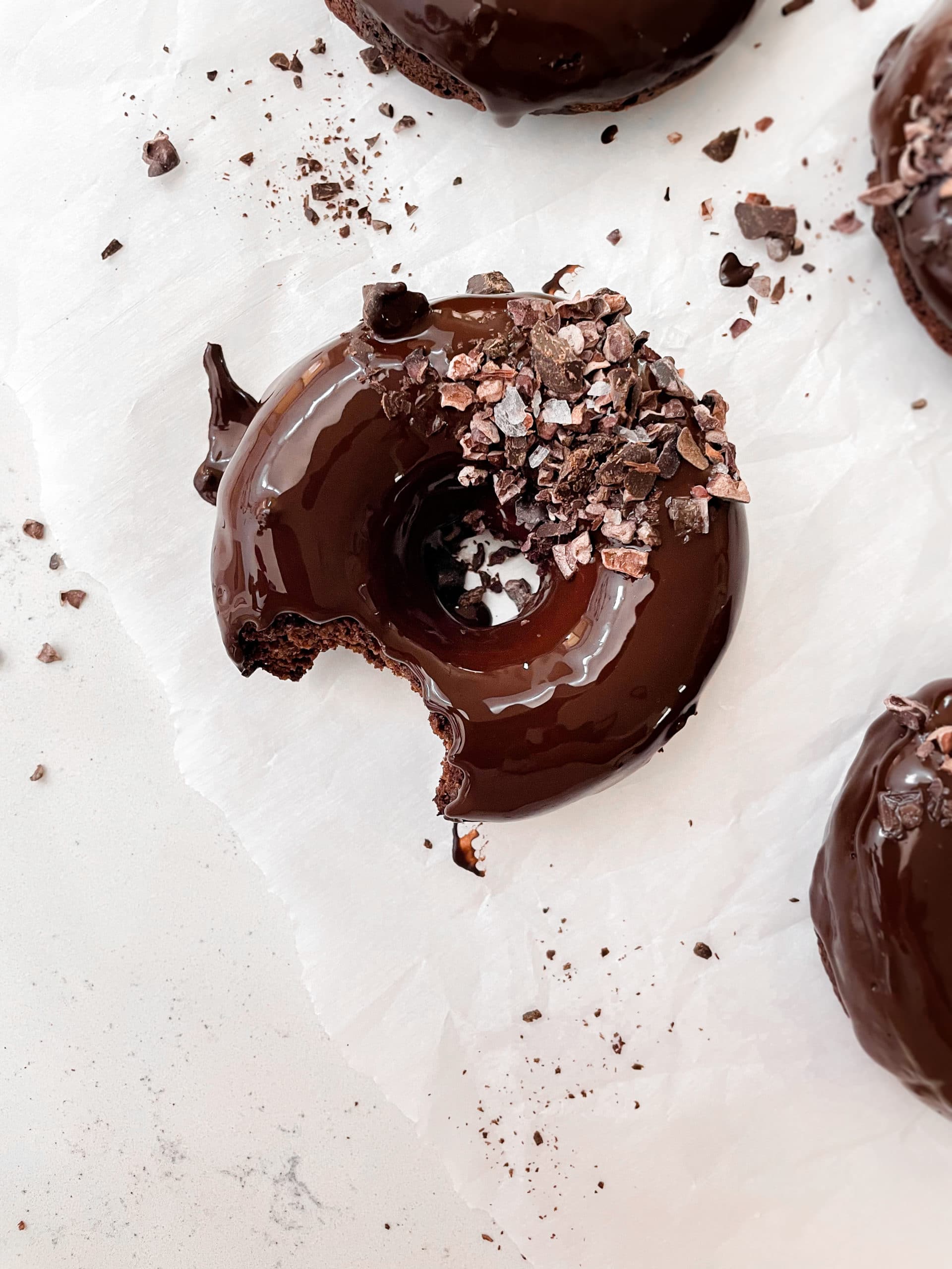 vegan chocolate baked donuts with chocolate glaze and flaky salt