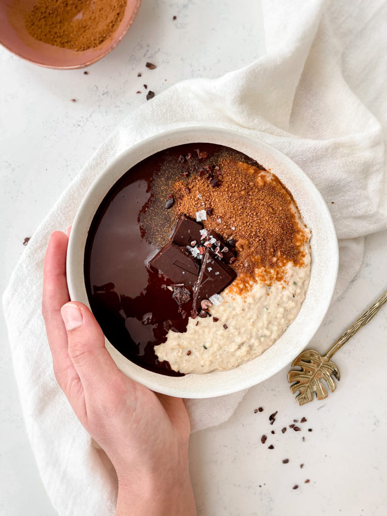 creamy vegan vanilla oatmeal topped with cinnamons sugar and chocolate ganache 