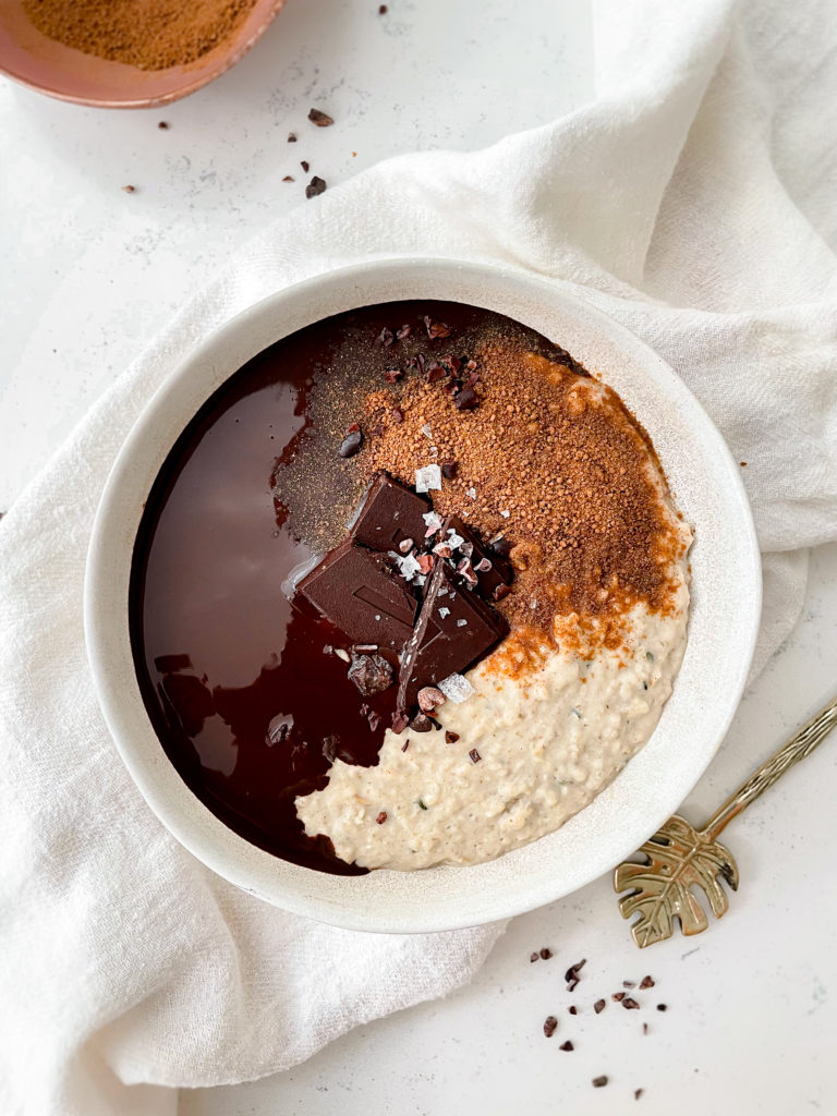 creamy vegan vanilla oatmeal topped with cinnamons sugar and chocolate ganache 