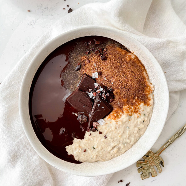 creamy vegan vanilla oatmeal topped with cinnamons sugar and chocolate ganache