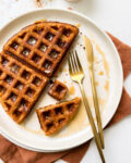 buttery pumpkin waffle on a beige plate