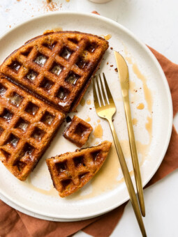 buttery pumpkin waffle on a beige plate