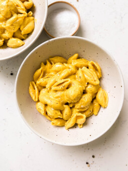 two white bowls of vegan butternut squash mac and cheese