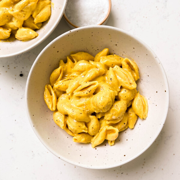 two white bowls of vegan butternut squash mac and cheese