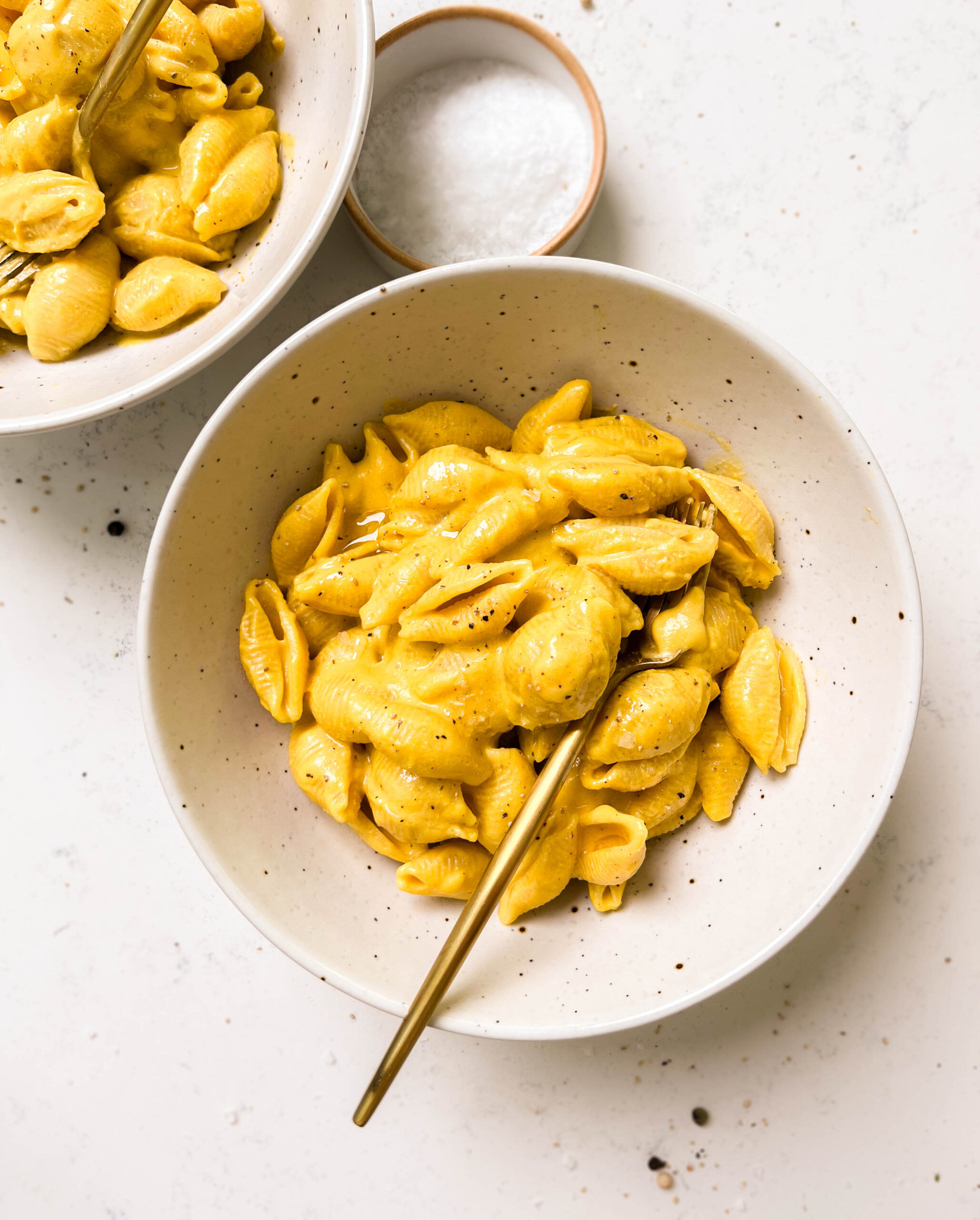 two white bowls of vegan butternut squash mac and cheese