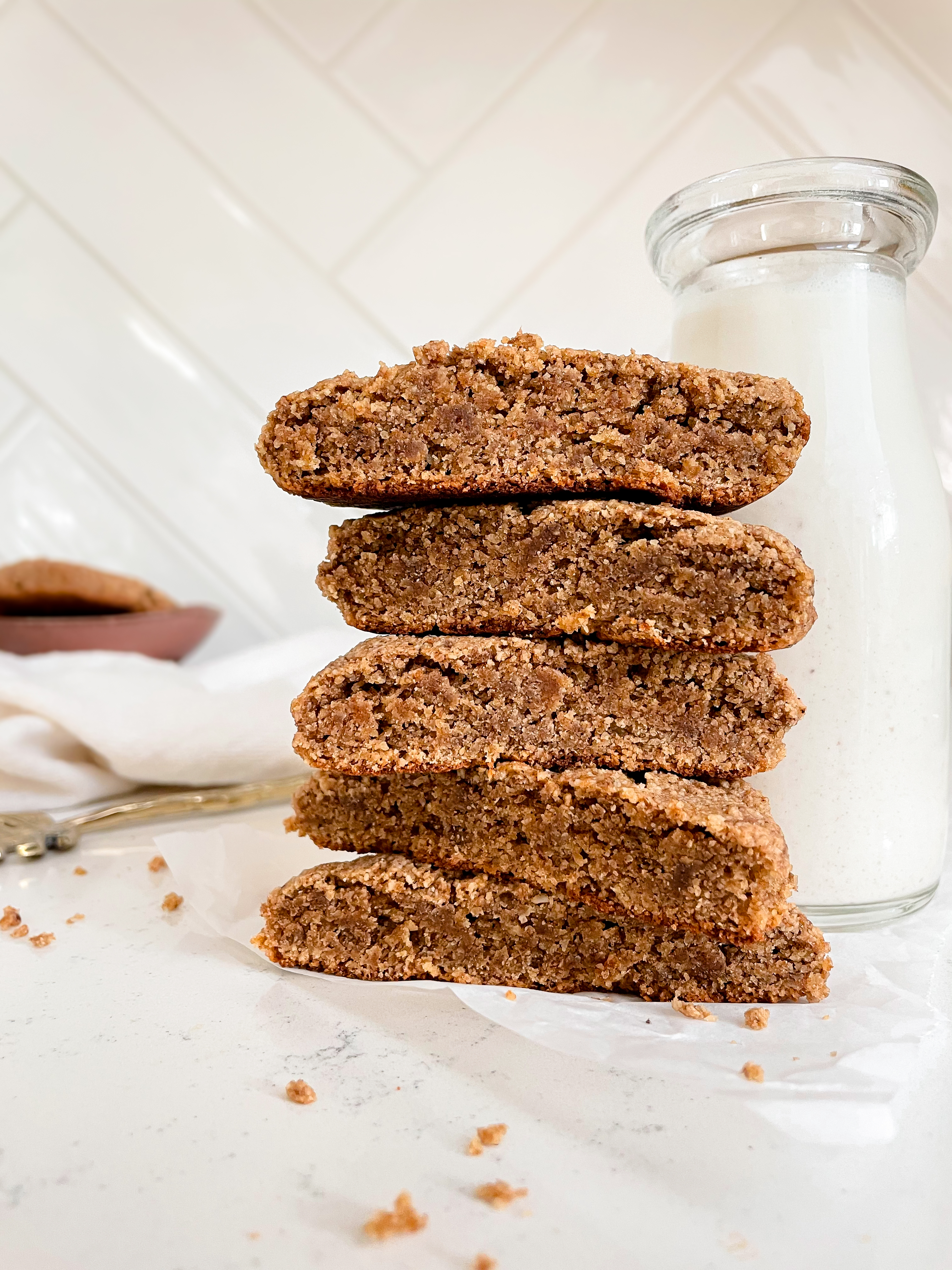 chewy chai cookies stacked next a milk bottle 