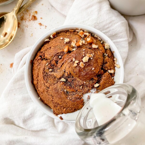 cinnamon roll baked oats in a ramekin on a linen