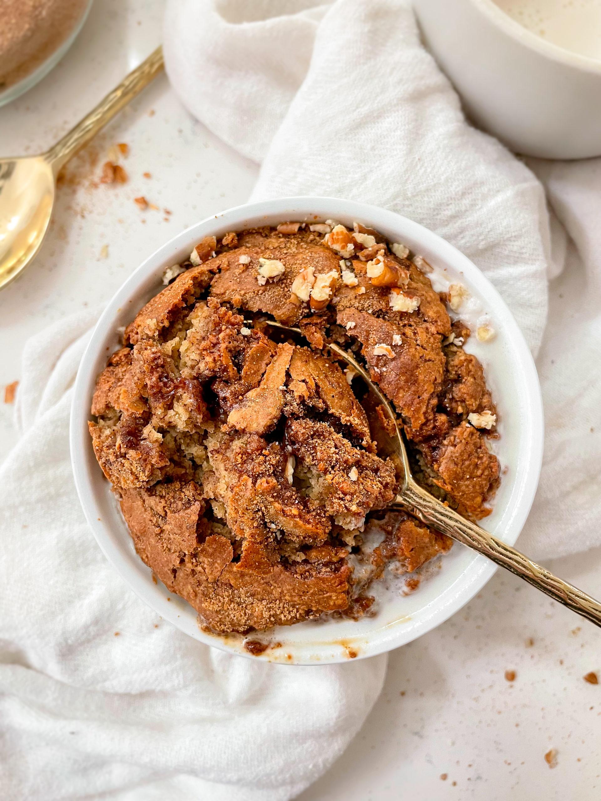 cinnamon roll baked oats in a ramekin on a linen