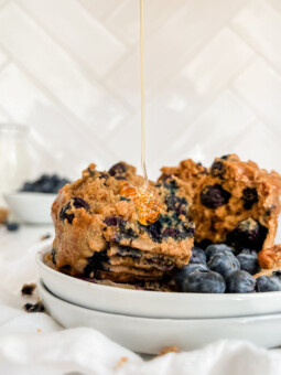 muffin on a plate with honey poured on top