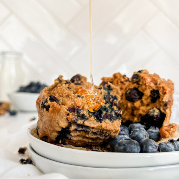 muffin on a plate with honey poured on top