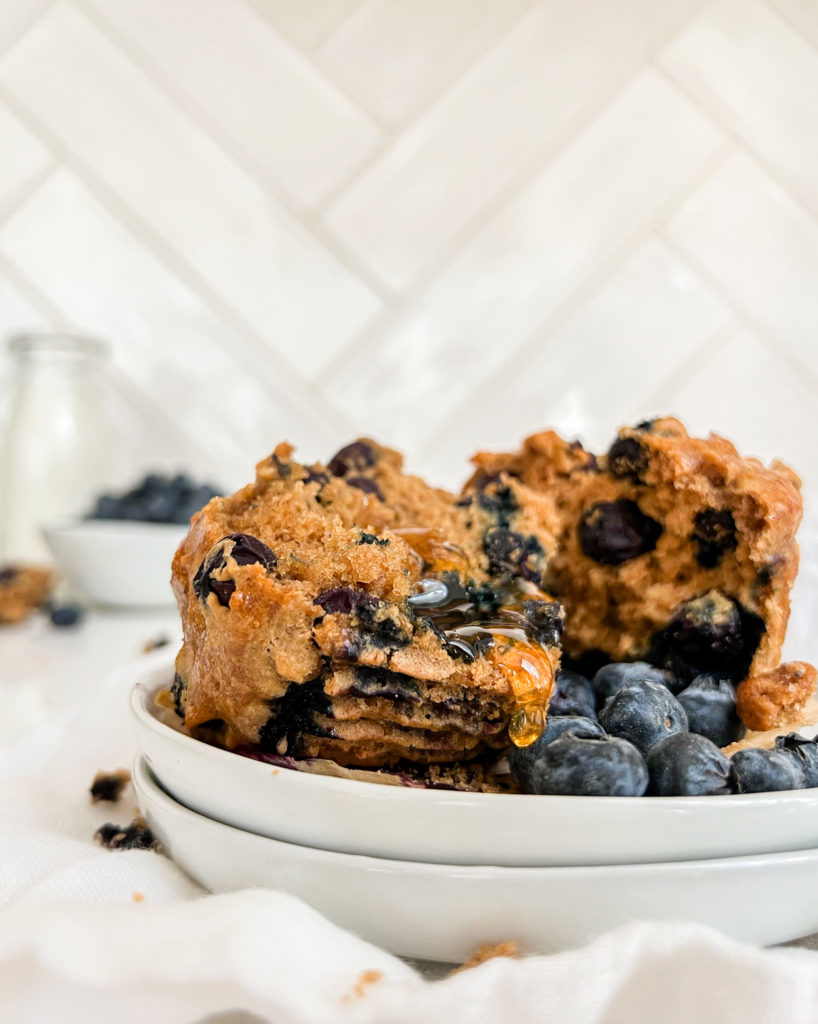 muffin on a plate with blueberries