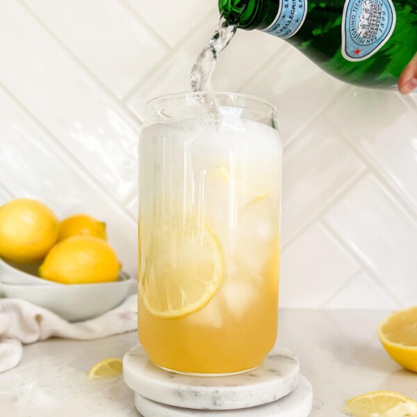 sparkling water poured into a glass of lemonade