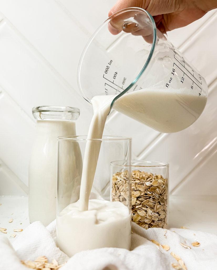 oat milk pouring into a cup