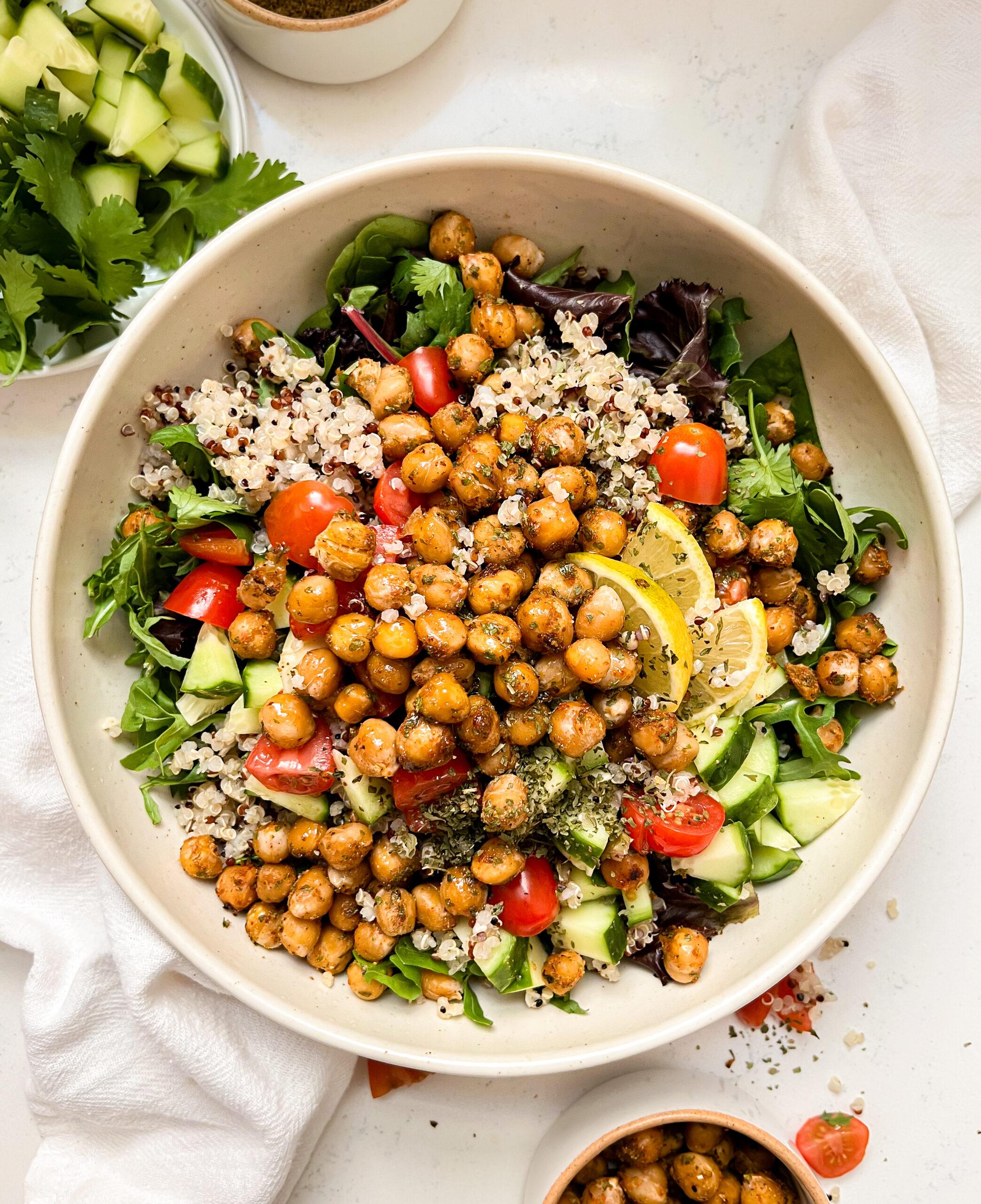 roasted chickpea salad bowl in a beige bowl next to a white linen cloth