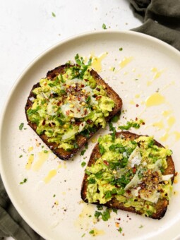 beige plate with avocado toast on top