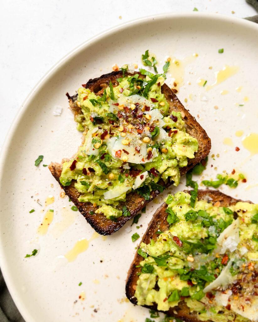 beige plate with avocado toast on top