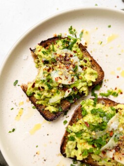 beige plate with avocado toast on top