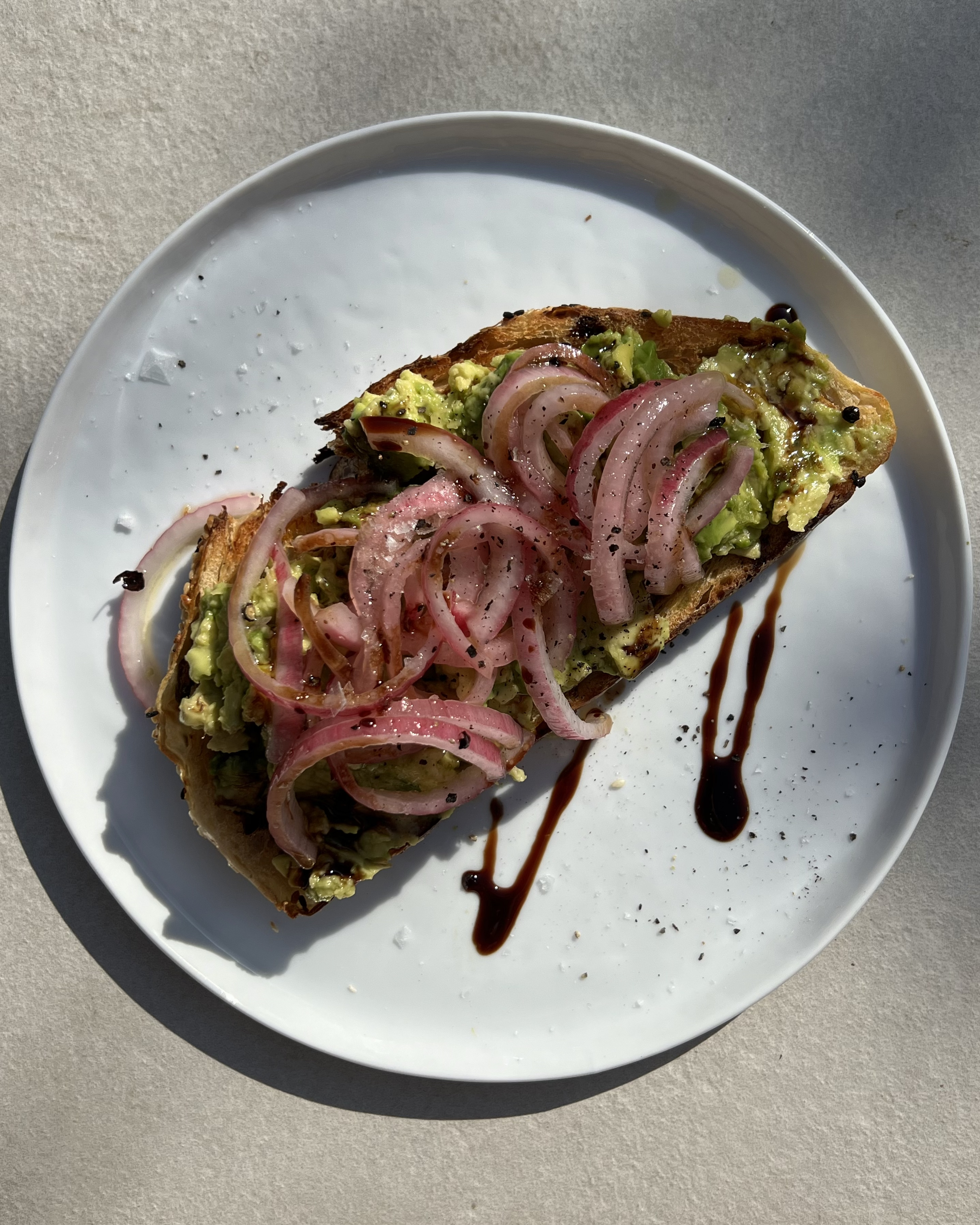 avocado toast on a white plate