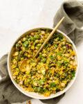 bowl of golden moroccan quinoa salad on a green linen cloth