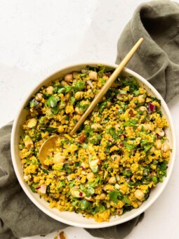 bowl of golden moroccan quinoa salad on a green linen cloth