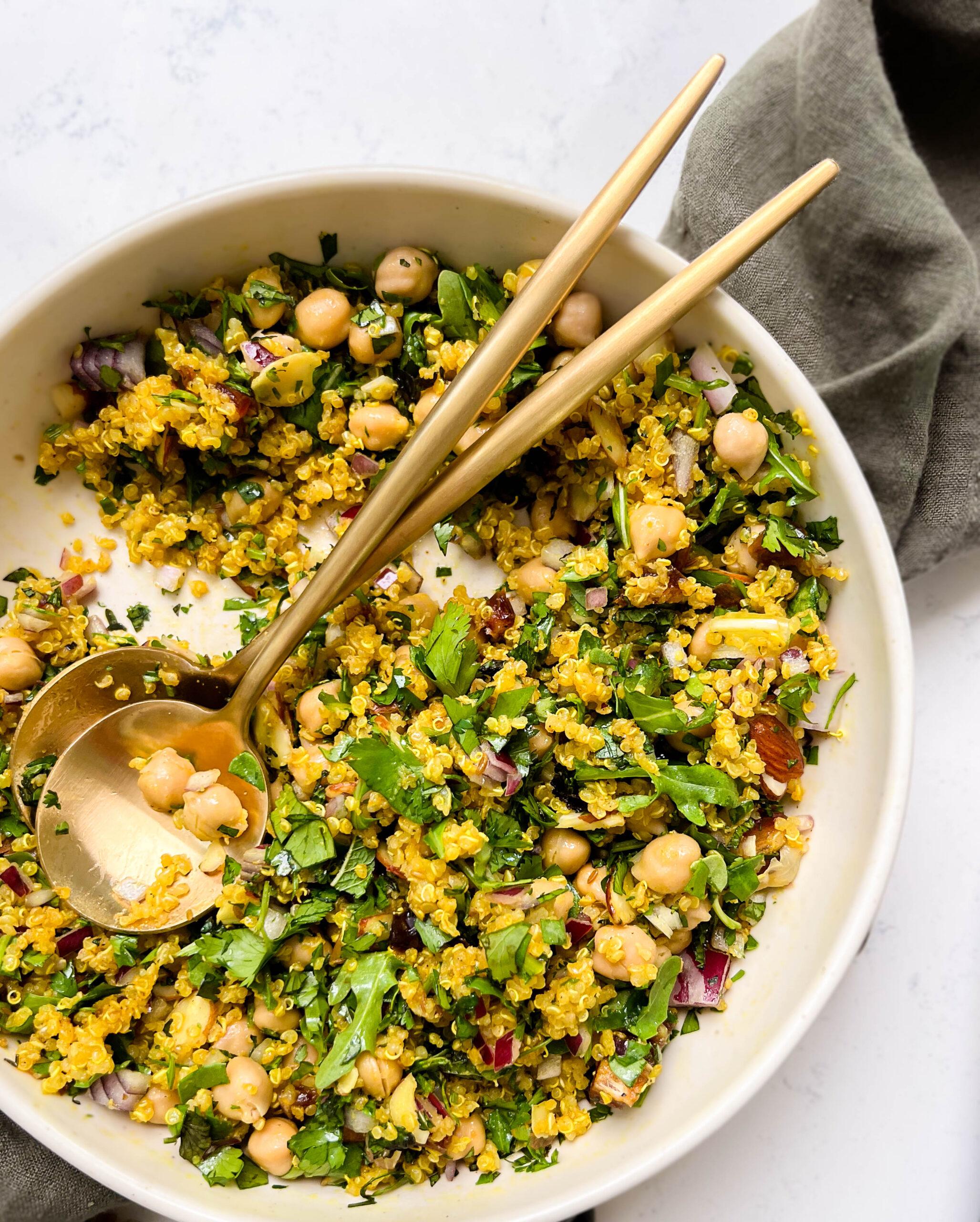 bowl of golden moroccan quinoa salad on a green linen cloth