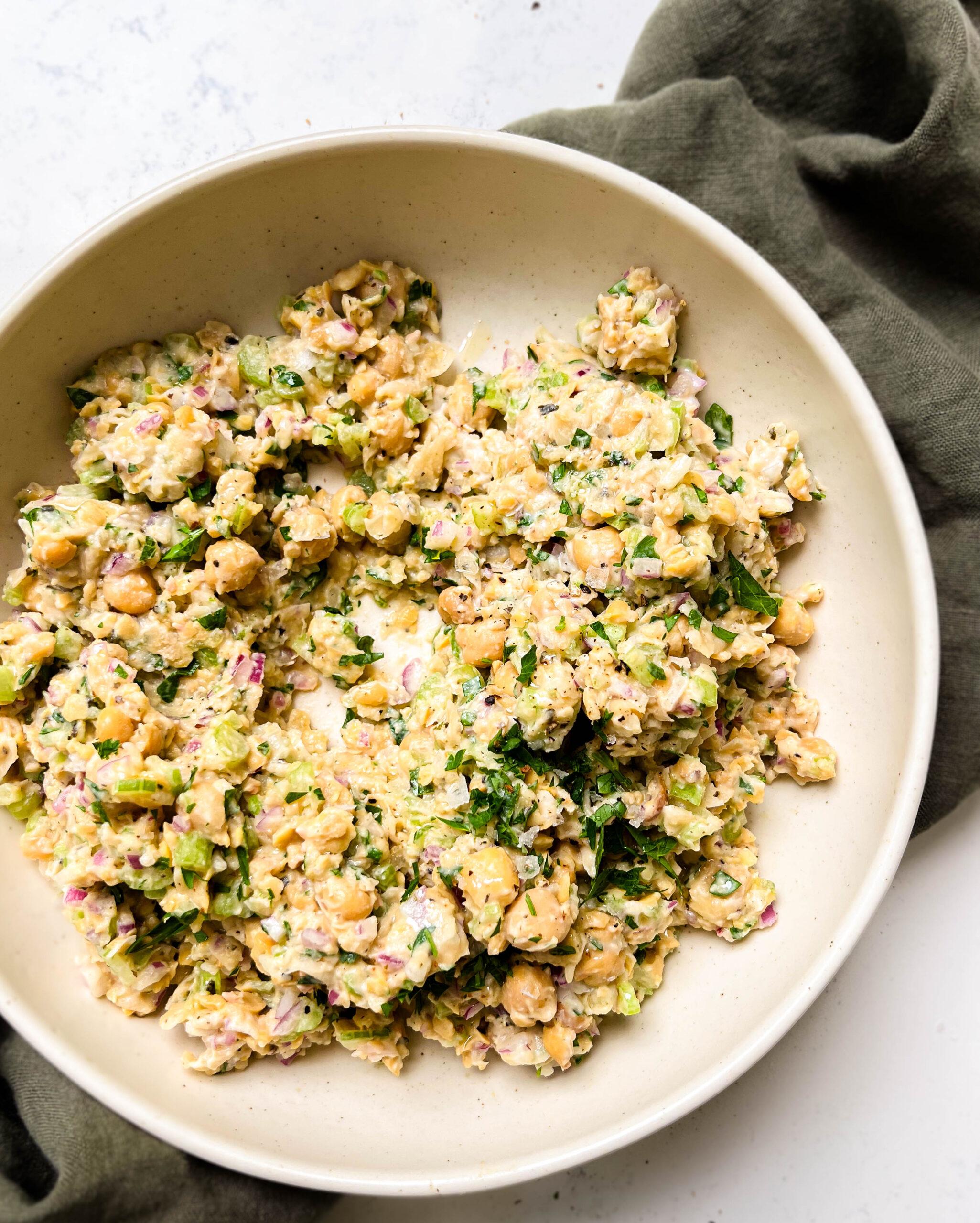 bowl of chickpea tuna salad on a green cloth