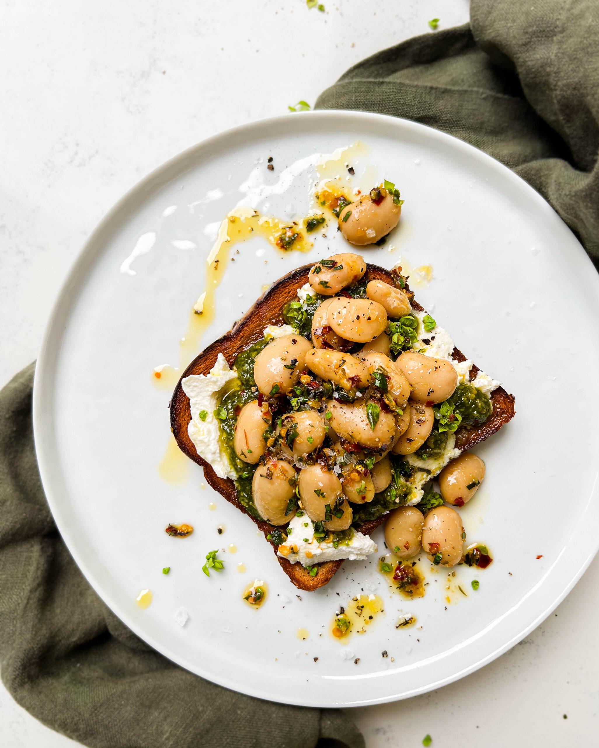 butter bean toast on a white plate