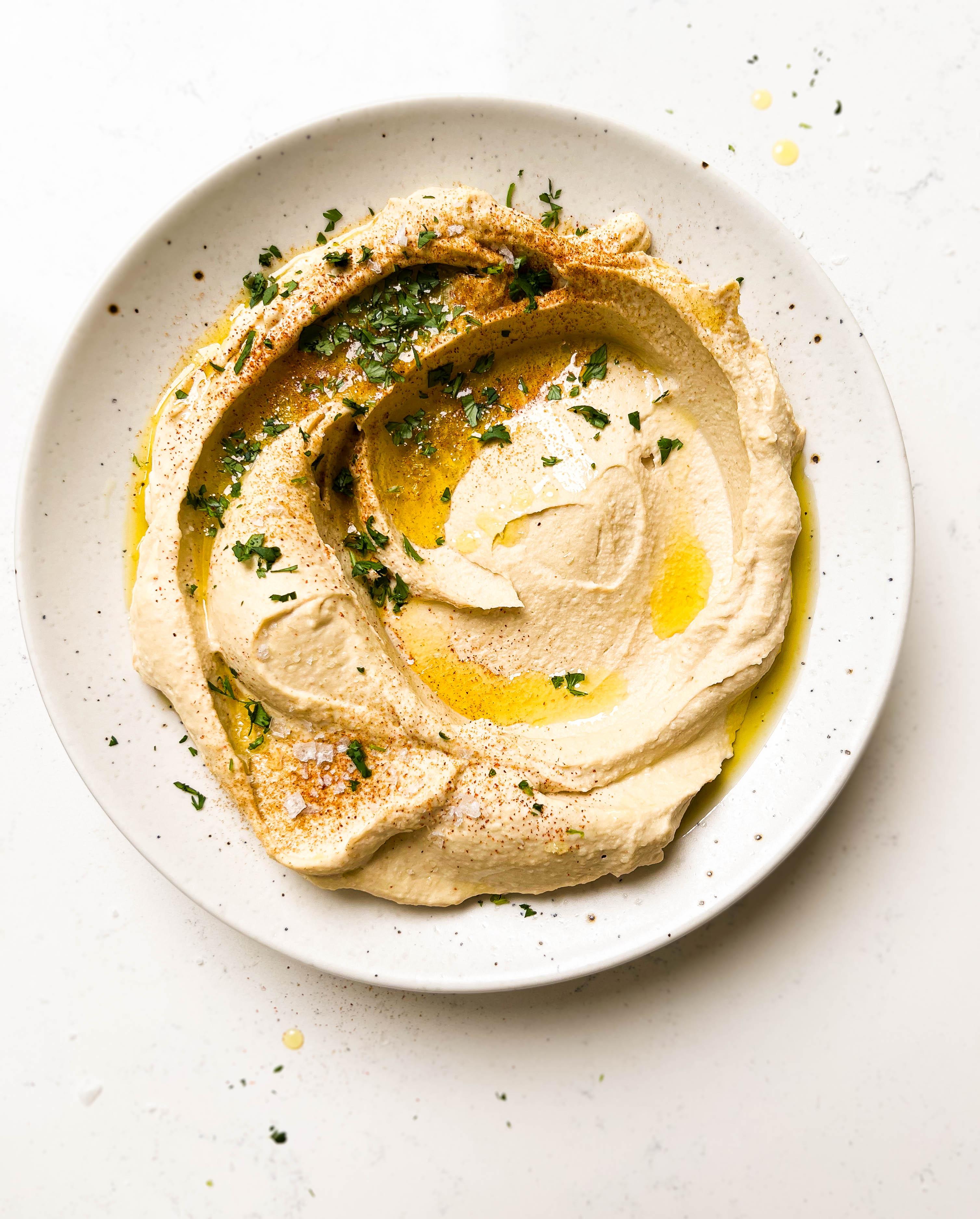 homemade hummus on a speckled plate