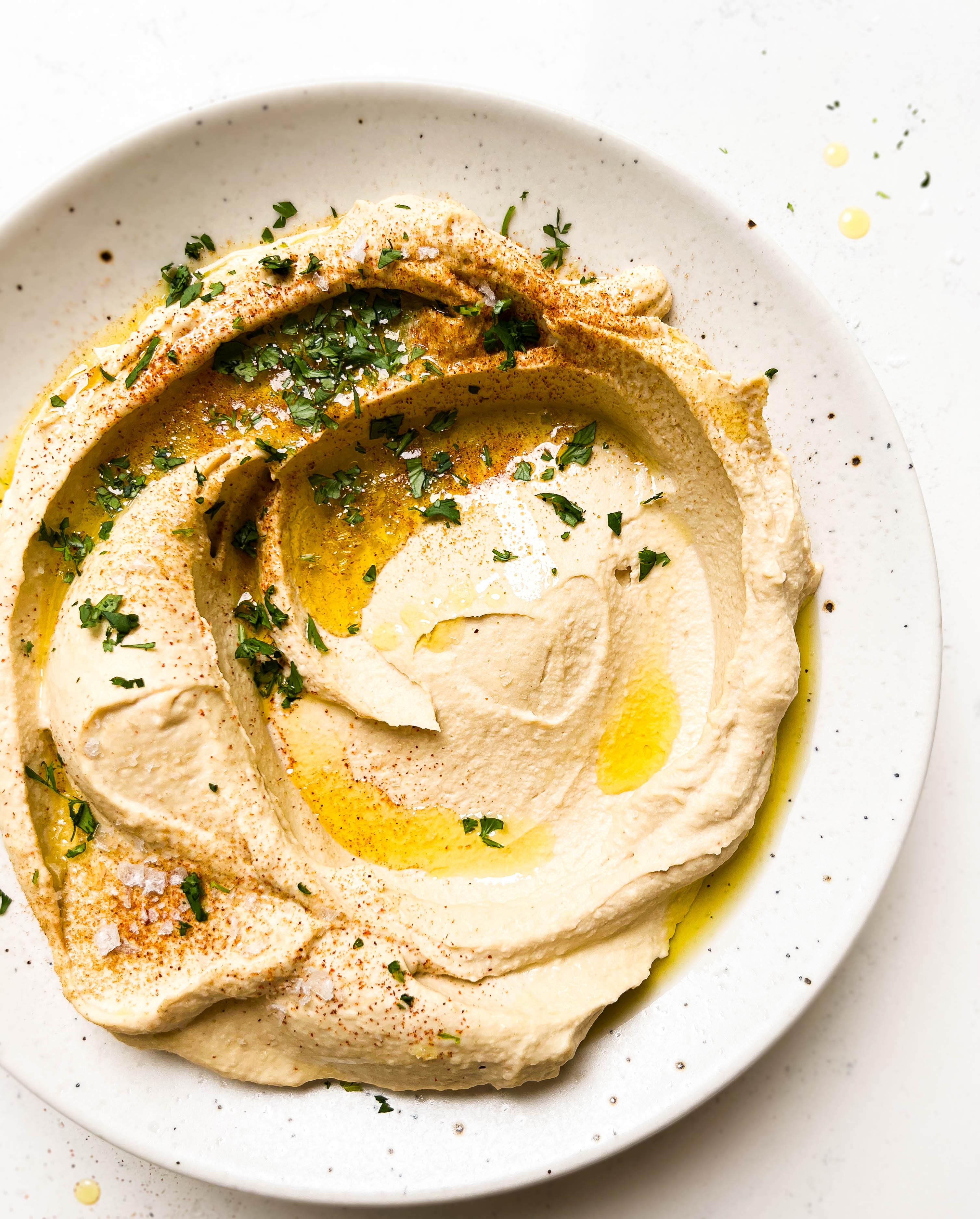 homemade hummus on a speckled plate