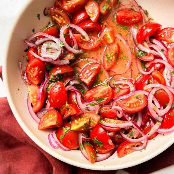 bowl of tomato salad on a red cloth