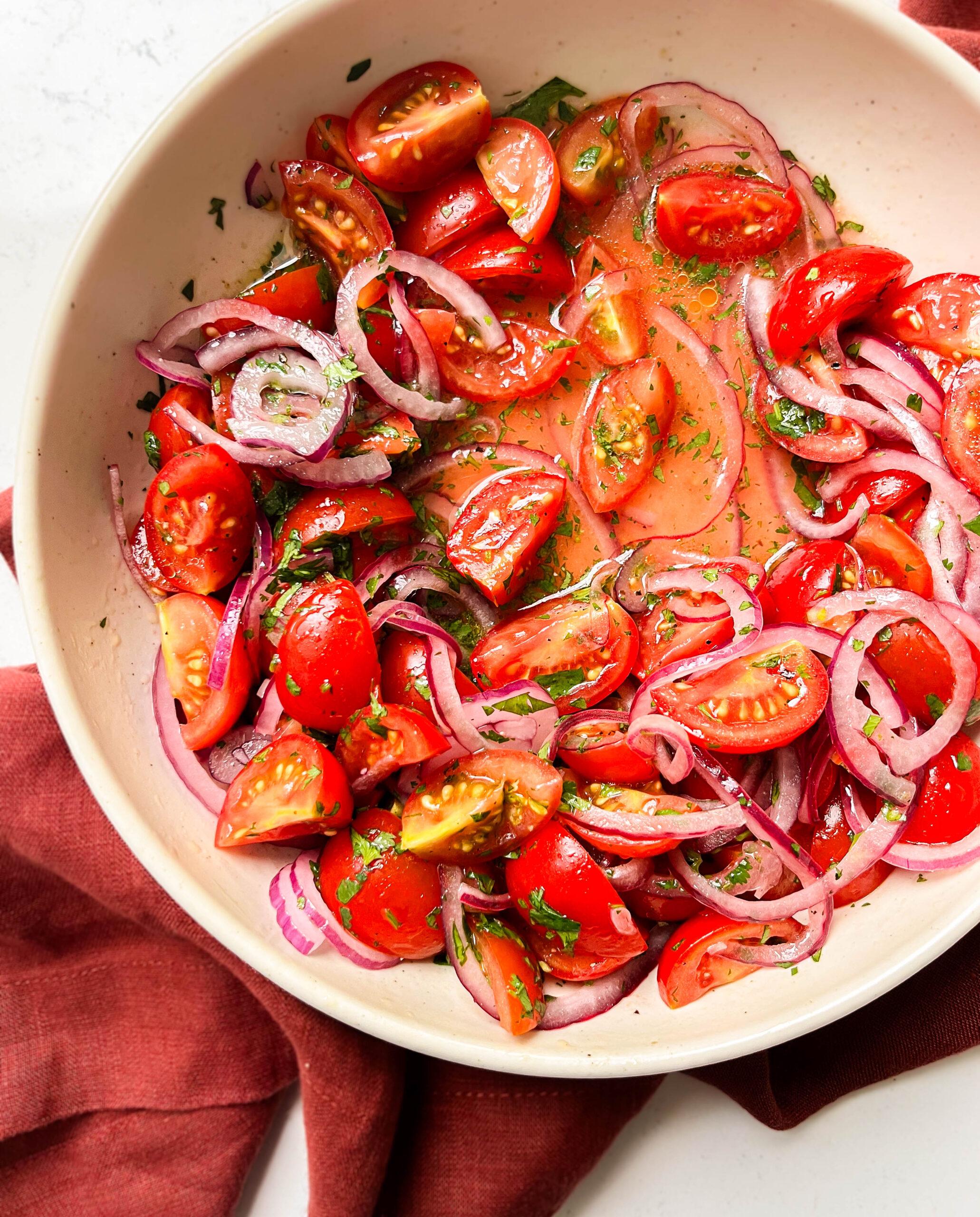 bowl of tomato salad on a red cloth