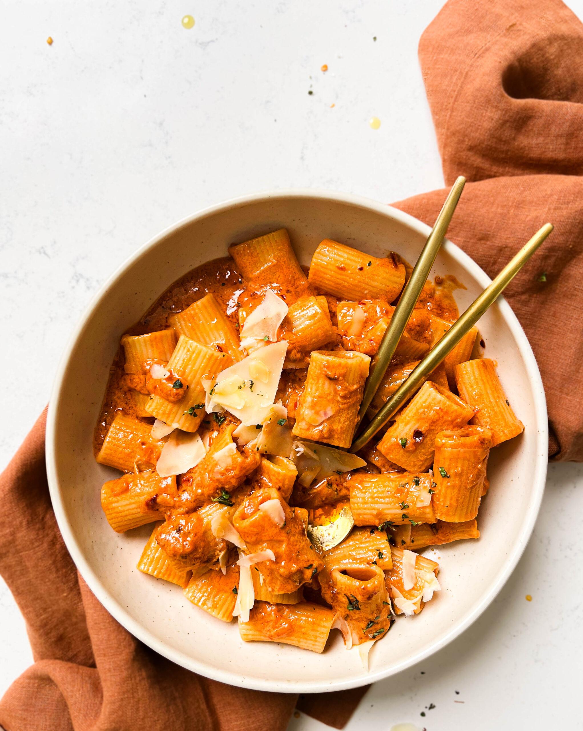 bowl of vegan vodka pasta on a brown linen cloth