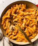 roasted tomato pasta in a pan with two spoons