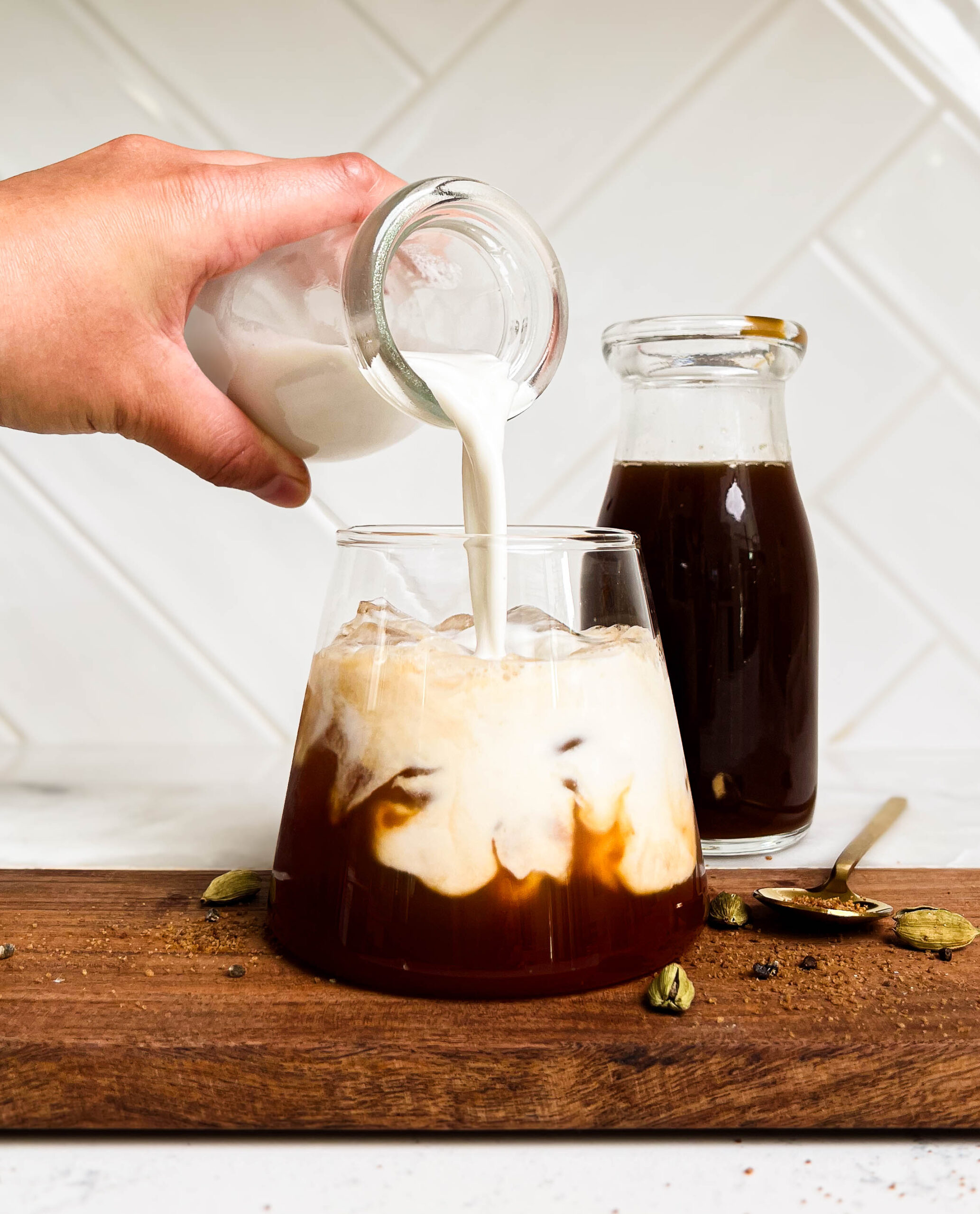 milk pouring into iced chai