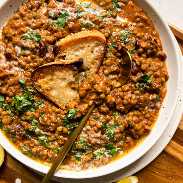 vegan dal makhani with bread in a speckled bowl