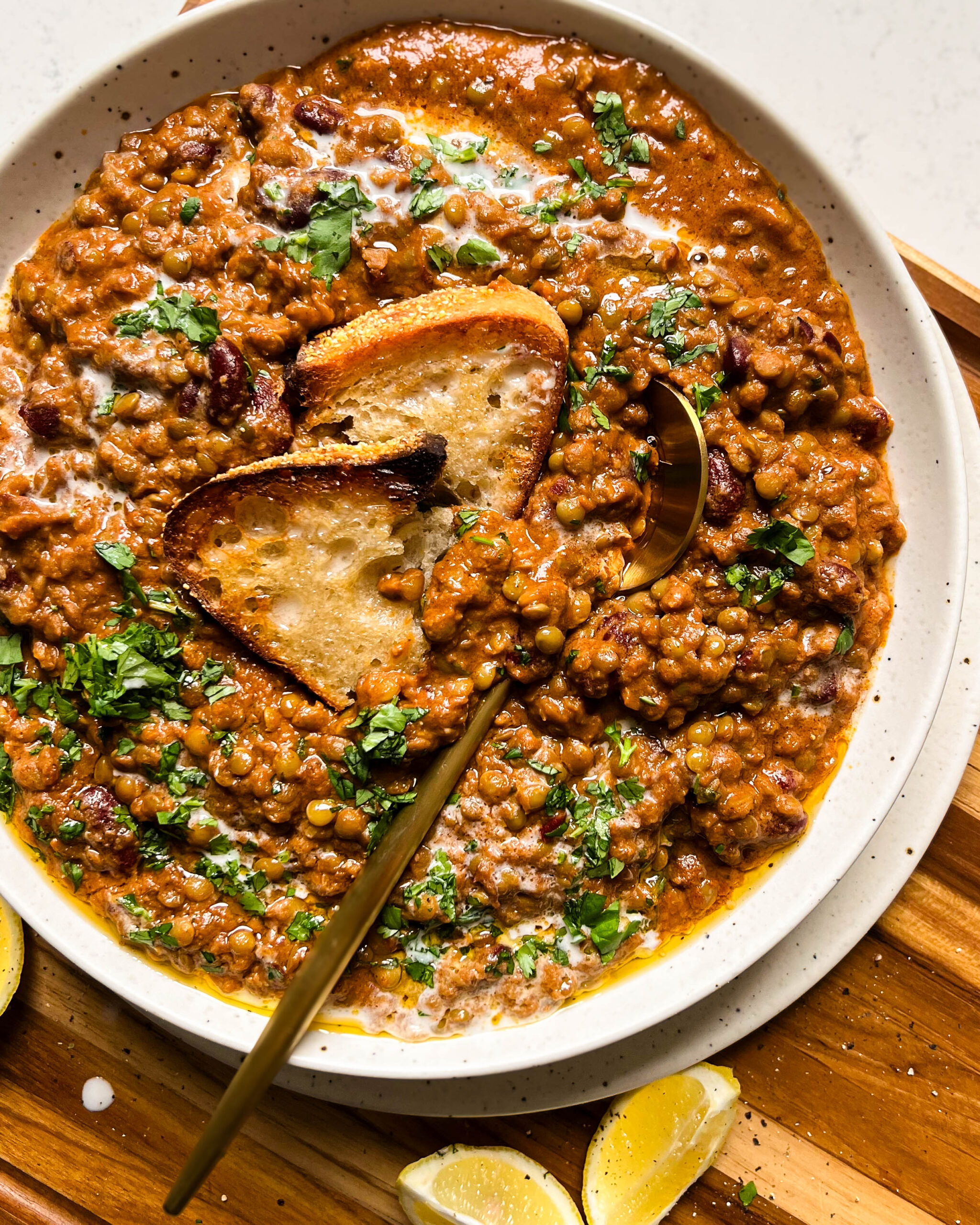 vegan dal makhani with bread in a speckled bowl 