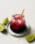 glass of TikTok tart cherry mocktail with lime wedges
