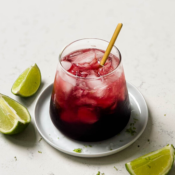 glass of TikTok tart cherry mocktail with lime wedges