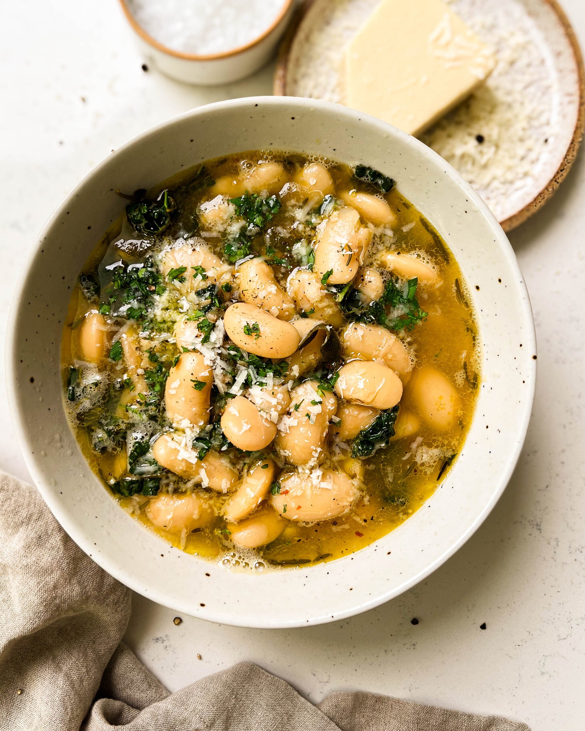 brothy beans in a white bowl