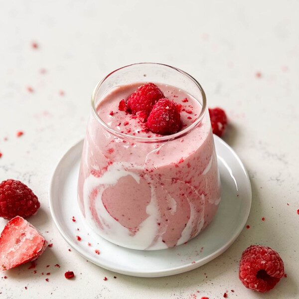 strawberry coconut cloud smoothie in a triangle glass